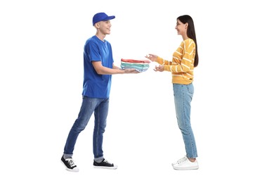 Dry-cleaning delivery. Courier giving folded clothes to woman on white background