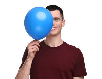 Happy young man with light blue balloon on white background