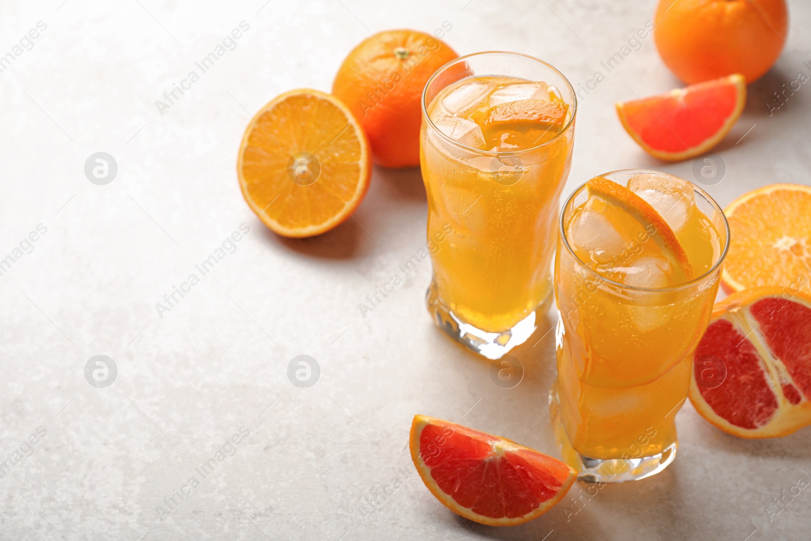 Photo of Delicious orange soda water on light table. Space for text