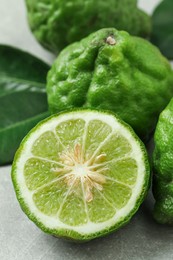 Photo of Fresh ripe bergamot fruits on light grey table, closeup