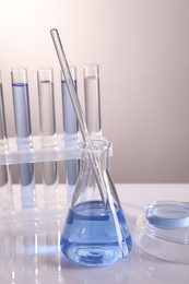 Laboratory analysis. Different glassware on table against light background