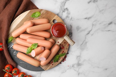 Photo of Delicious boiled sausages with spices, sauce and tomatoes on white marble table, flat lay. Space for text