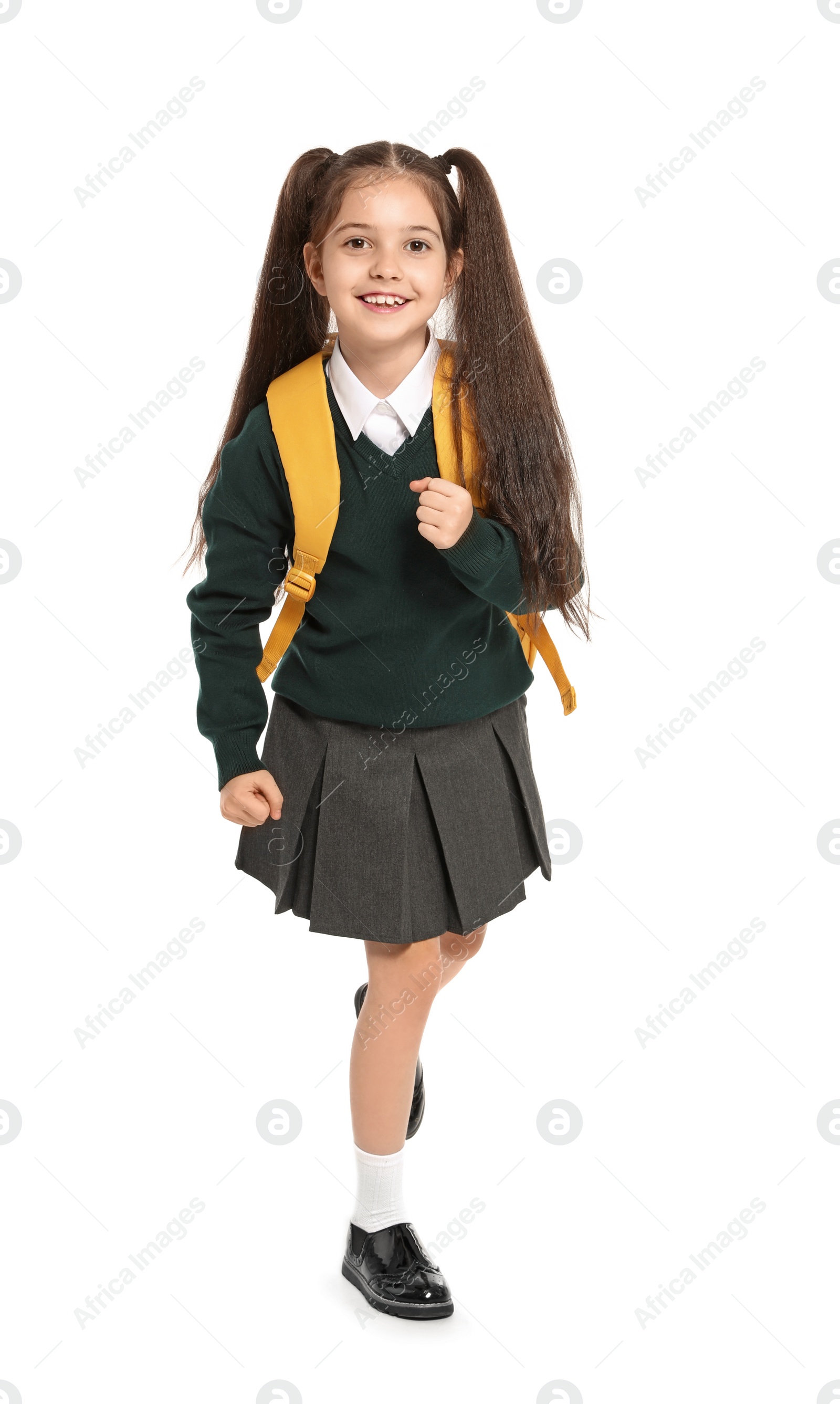 Photo of Little girl in stylish school uniform on white background