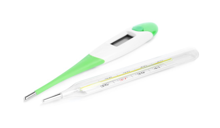 Photo of Digital and mercury thermometers on white background