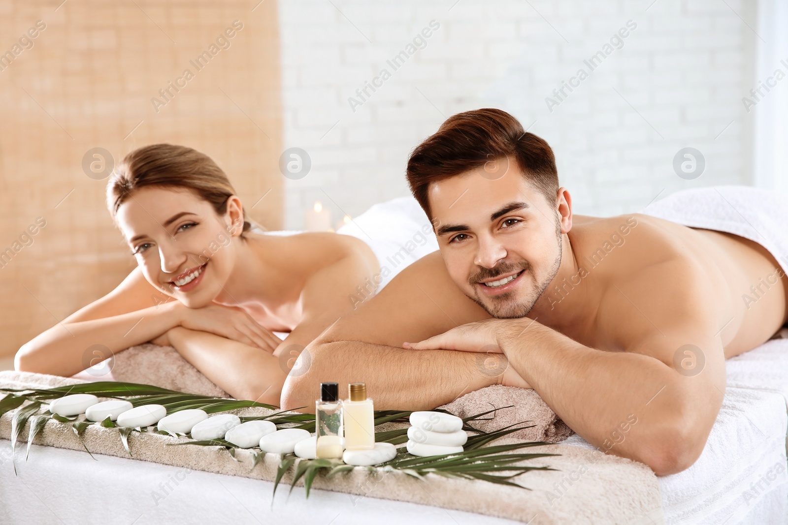 Photo of Romantic young couple relaxing in spa salon