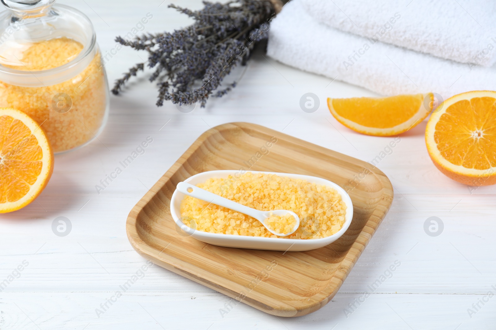 Photo of Sea salt, lavender, orange and towels on white wooden table