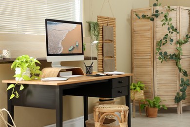 Photo of Light room interior with comfortable workplace near window