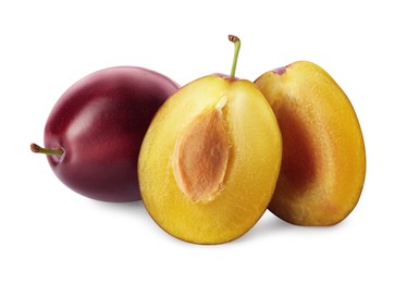 Whole and cut ripe plums on white background