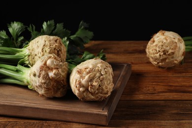 Fresh raw celery roots on wooden table