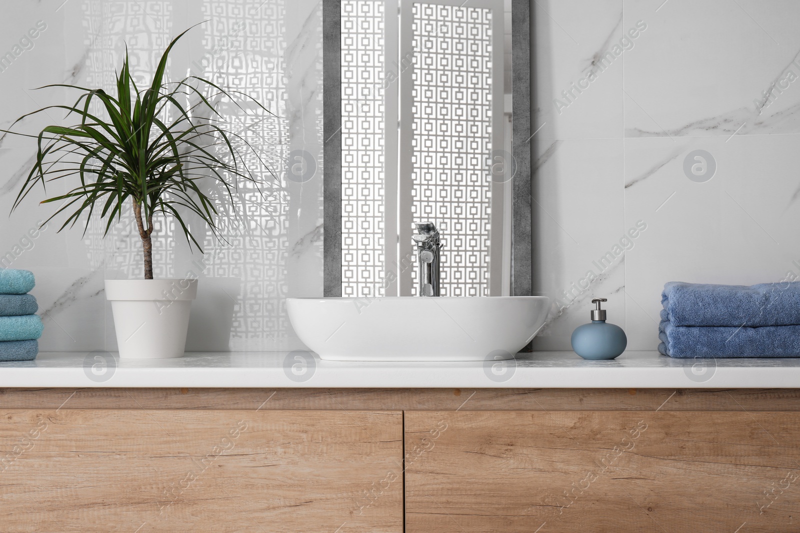 Photo of Modern mirror and vessel sink in stylish bathroom