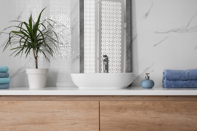 Modern mirror and vessel sink in stylish bathroom