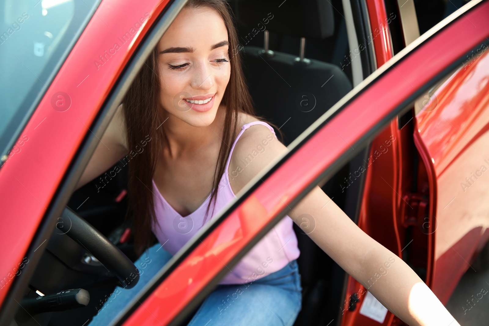 Photo of Young woman on driver's seat of car