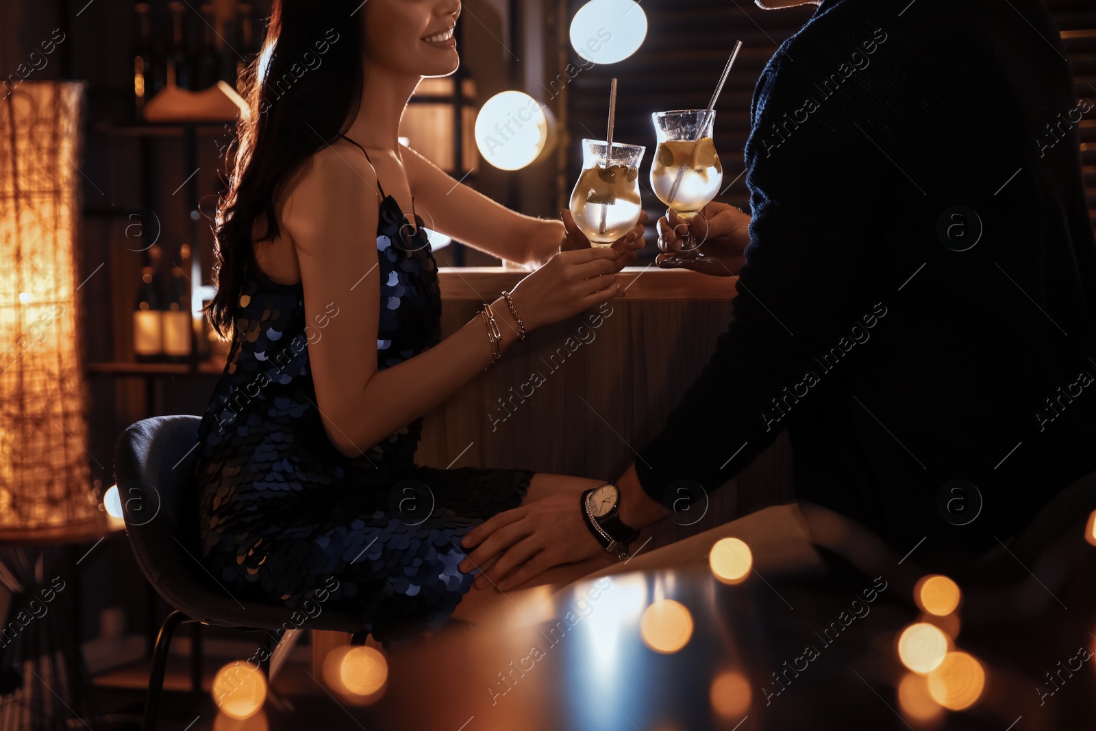 Photo of Man and woman flirting with each other in bar, closeup