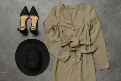 Stylish dress, shoes and hat on grey stone background, flat lay