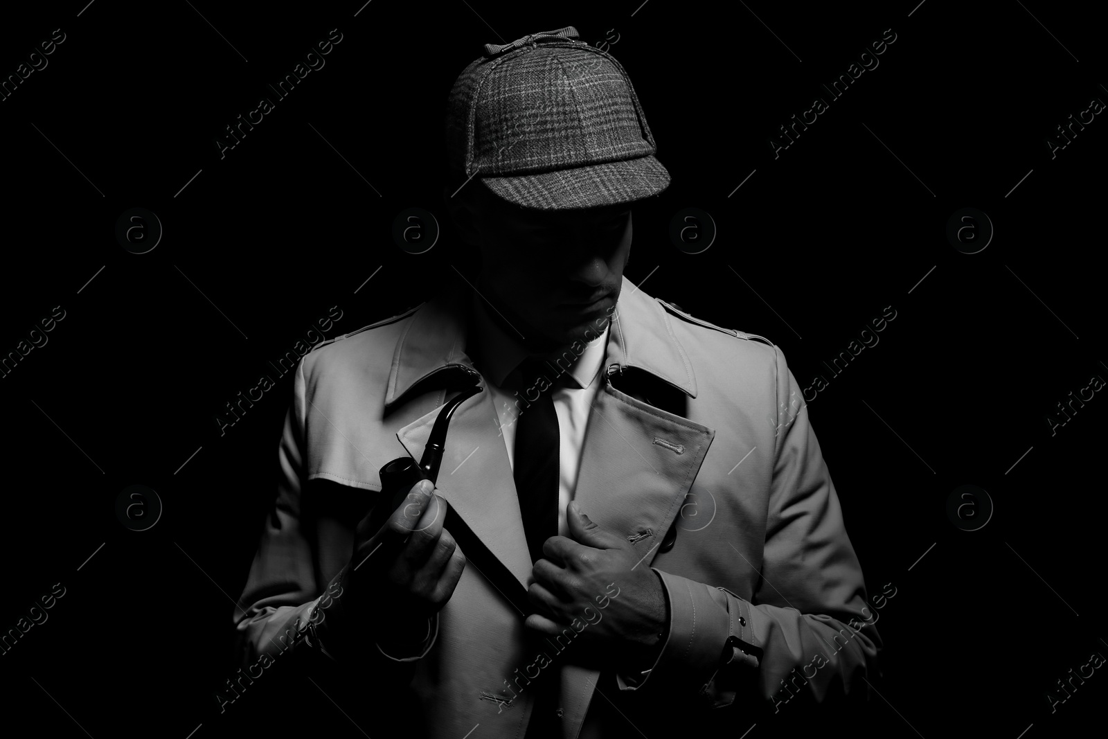 Photo of Old fashioned detective with smoking pipe on dark background, black and white effect