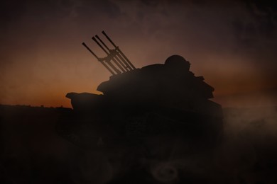 Image of Silhouette of armored fighting vehicle on battlefield in night