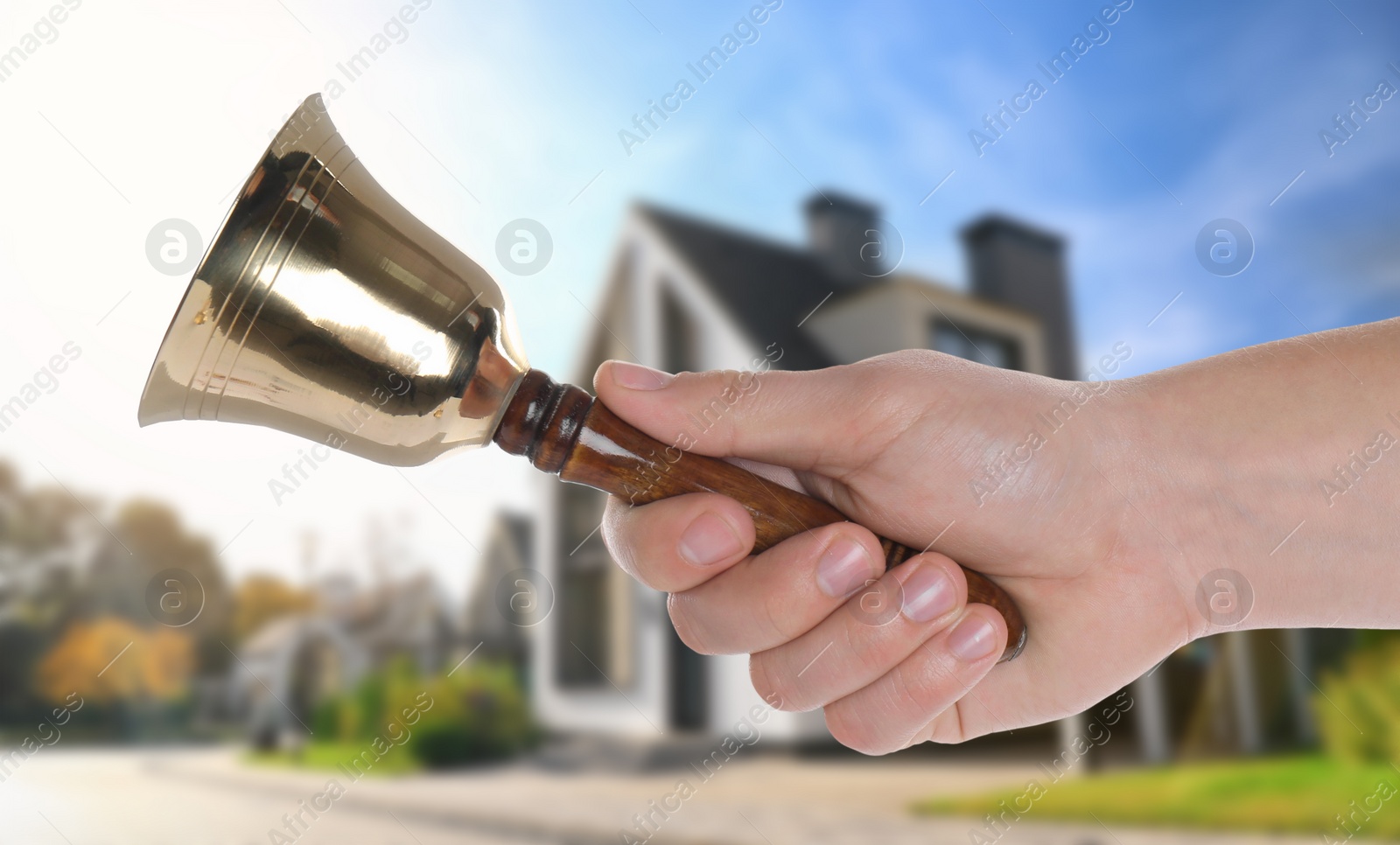Image of Woman with school bell outdoors on sunny day, closeup