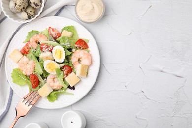 Delicious Caesar salad with shrimps and fork served on white textured table, flat lay. Space for text