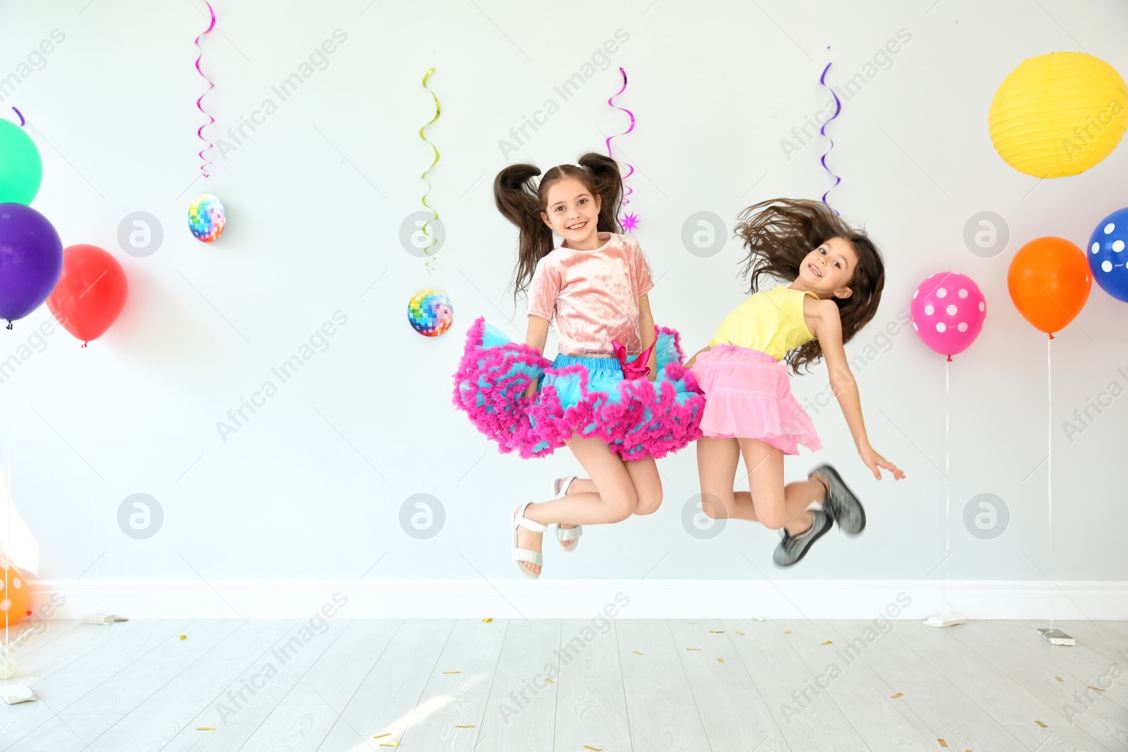 Photo of Adorable little girls at birthday party indoors