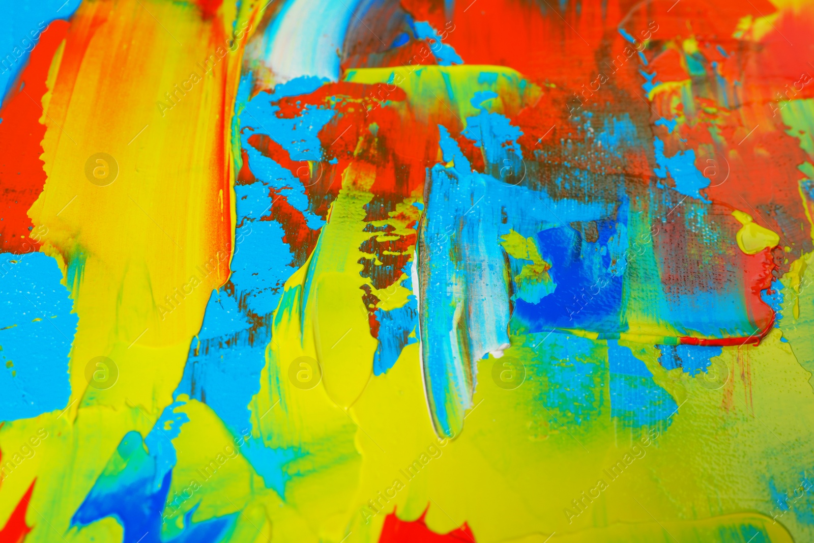 Photo of Closeup view of artist's palette with mixed bright paints as background