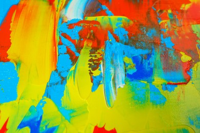 Photo of Closeup view of artist's palette with mixed bright paints as background