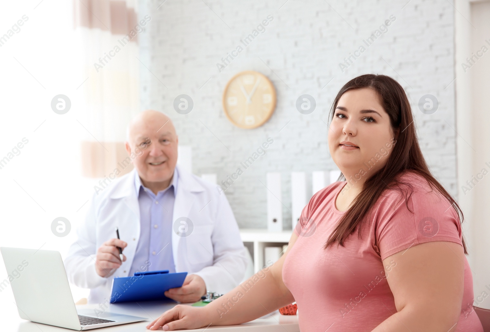 Photo of Overweight woman having consultation at doctor's office