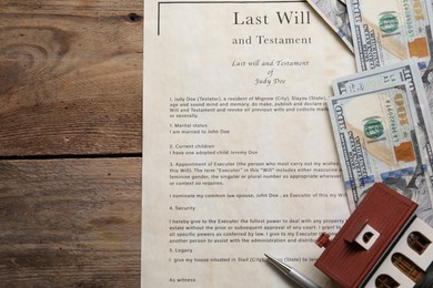 Photo of Last Will and Testament, dollar bills, house model and pen on wooden table, flat lay. Space for text