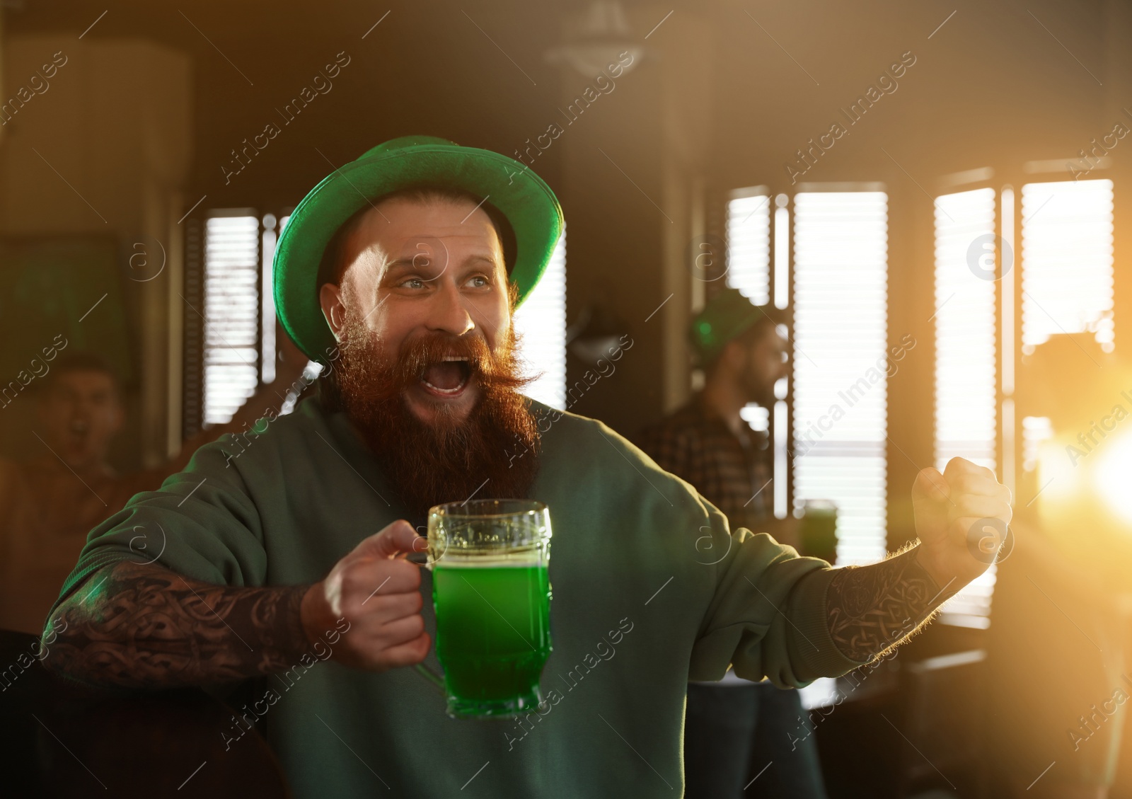 Photo of Man with glass of green beer in pub. St. Patrick's Day celebration