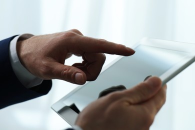 Closeup view of man using new tablet indoors