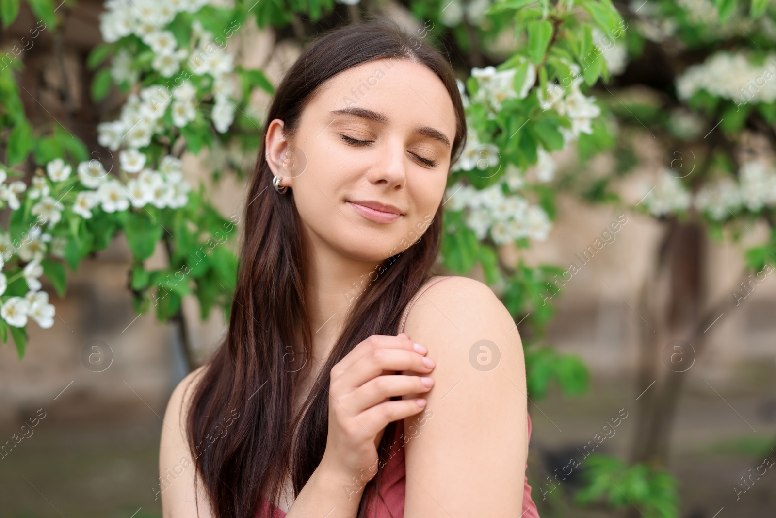 Photo of Beautiful woman near blossoming tree on spring day