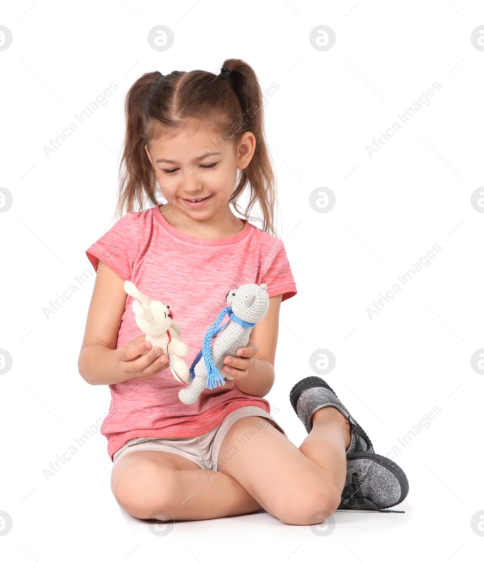 Photo of Little child playing with toy animals on white background. Indoor entertainment