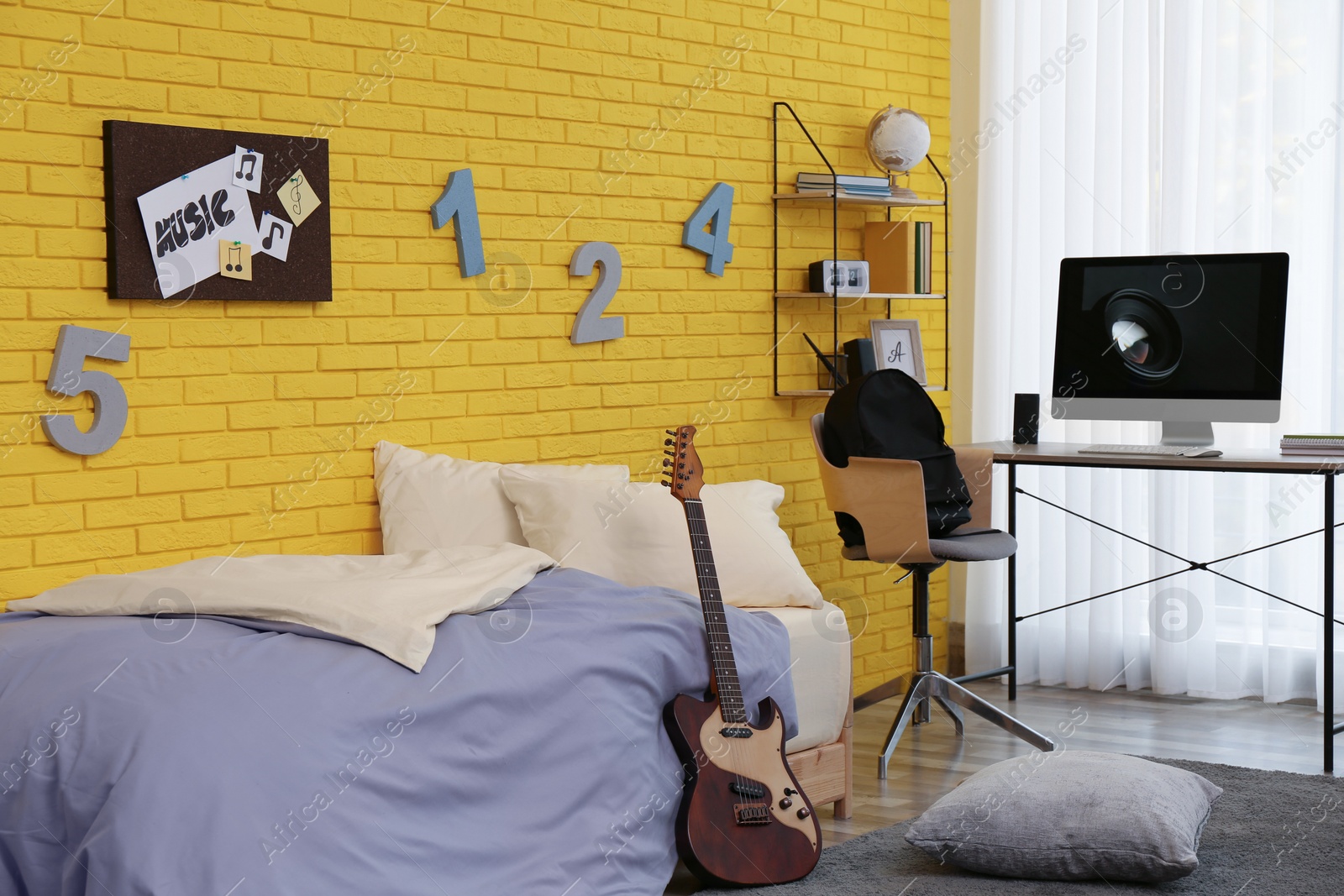 Photo of Stylish teenager's room interior with computer and bed