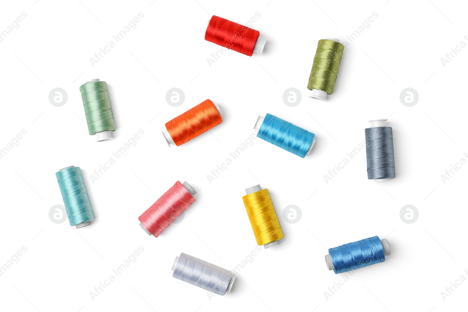 Photo of Color sewing threads on white background, top view