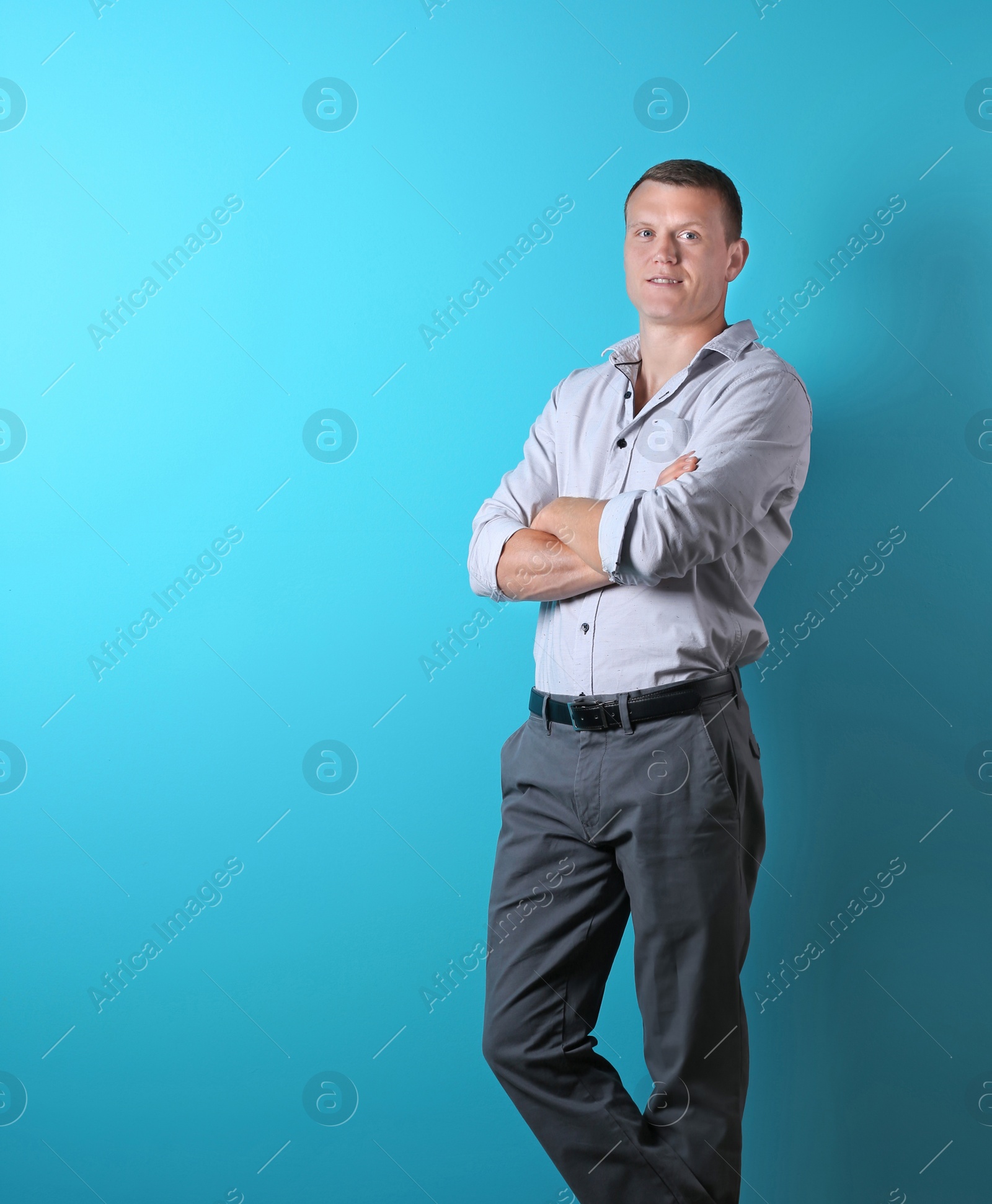 Photo of Handsome confident young man on color background