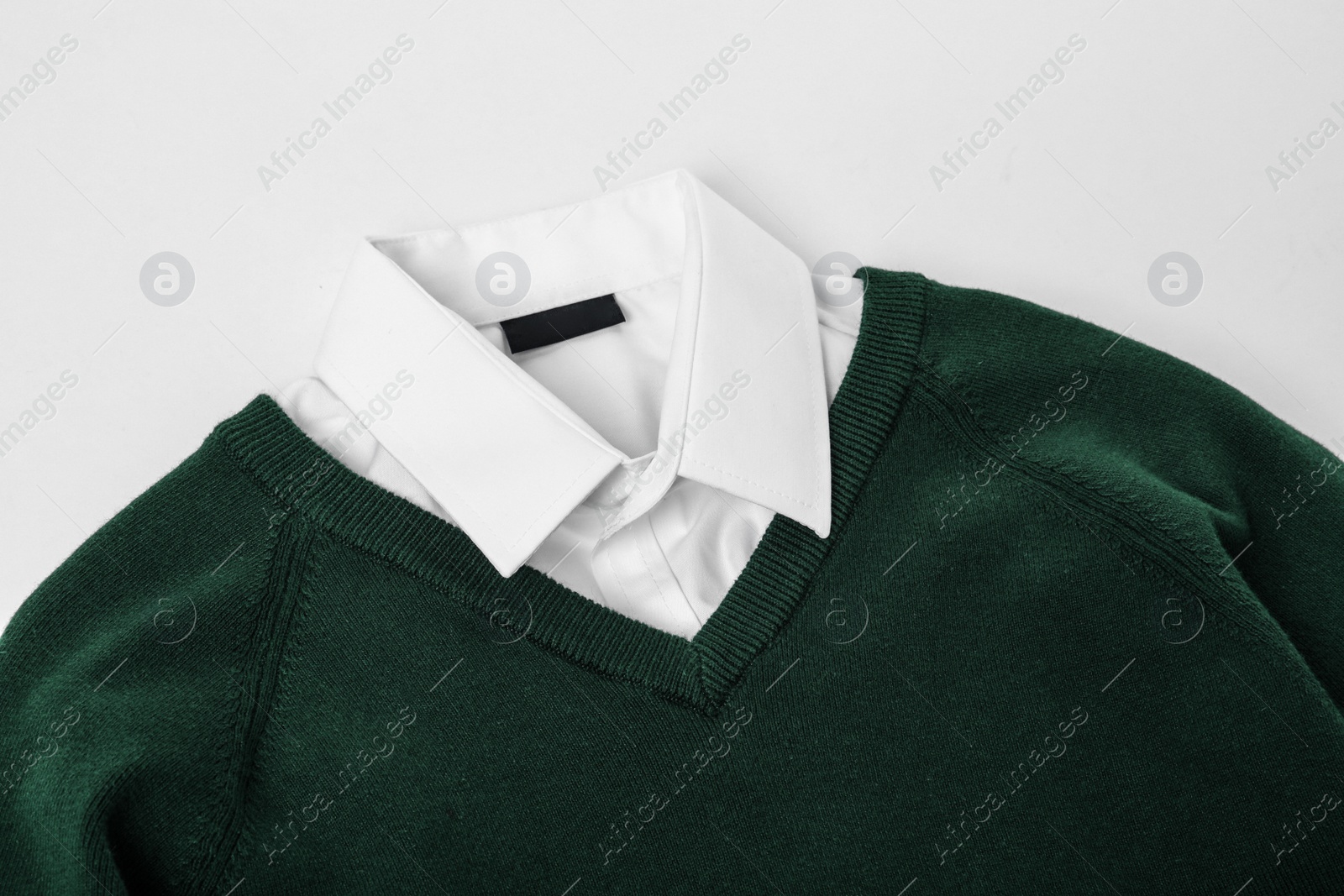 Photo of New stylish school uniform on white background, closeup