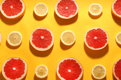 Flat lay composition with tasty ripe grapefruit slices on yellow background