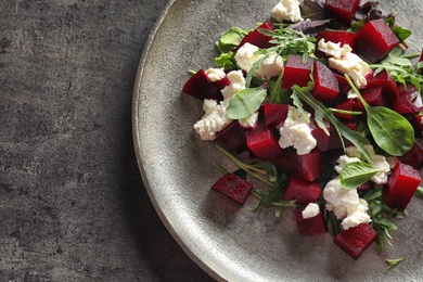 Plate with delicious beet salad on grey background, top view