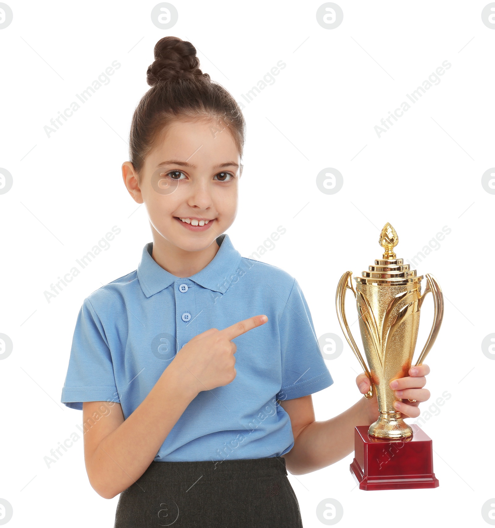 Photo of Happy girl in school uniform with golden winning cup isolated on white