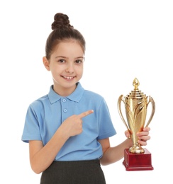 Happy girl in school uniform with golden winning cup isolated on white