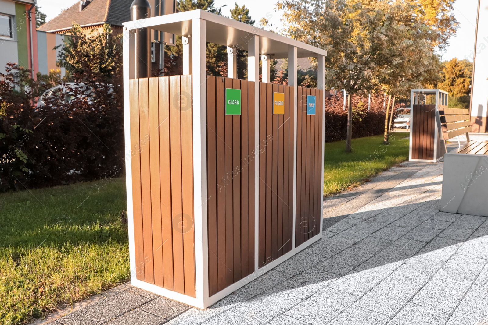 Photo of Different sorting bins for waste recycling on sunny day outdoors