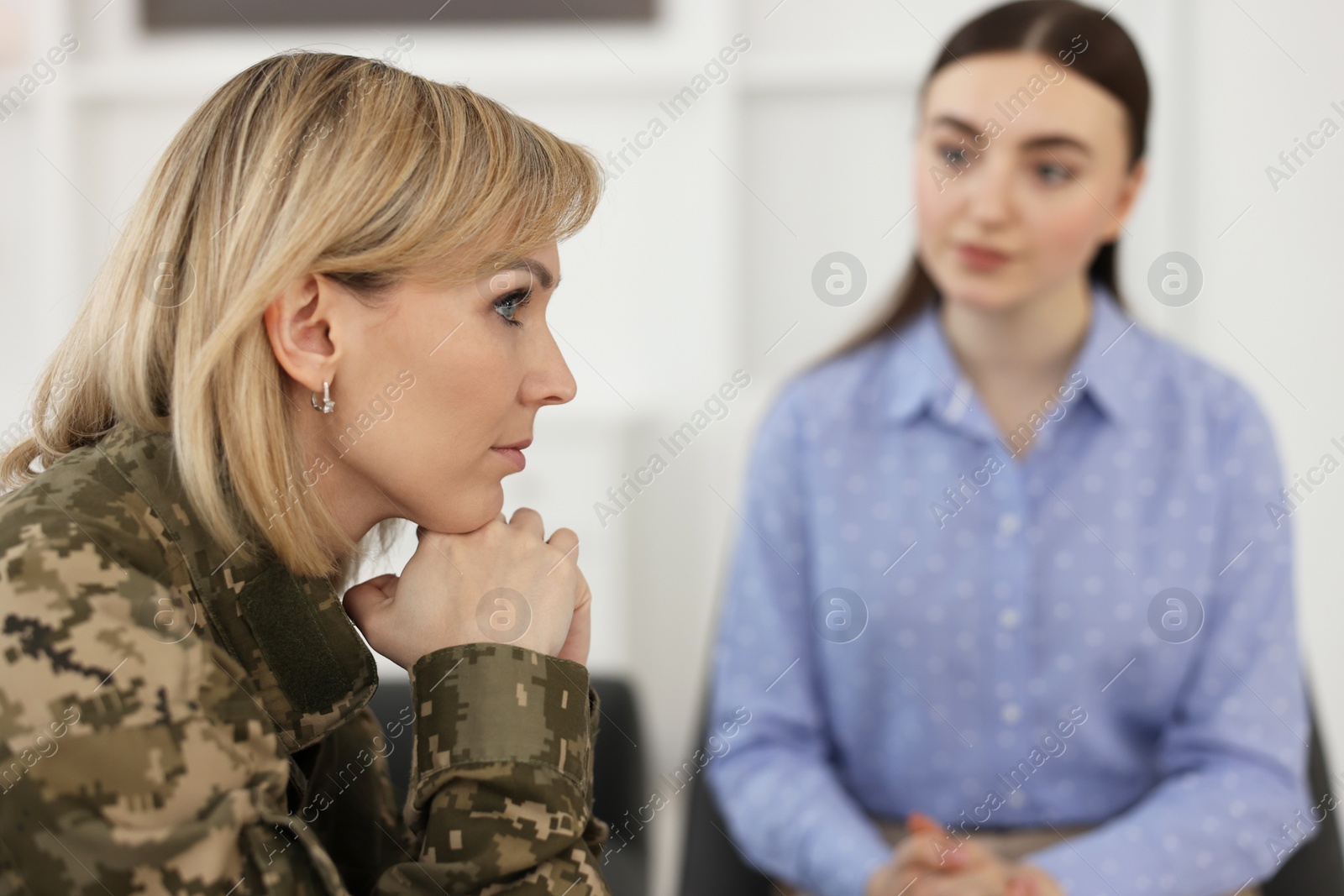 Photo of Psychotherapist working with military woman in office