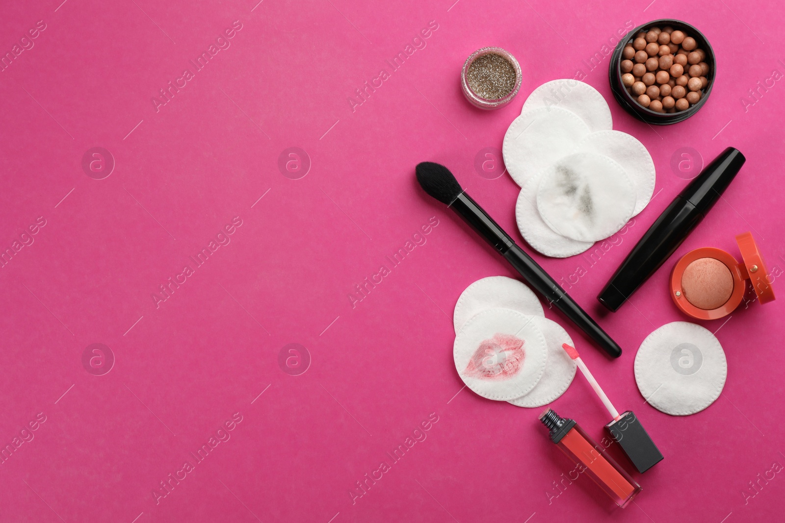 Photo of Clean and dirty cotton pads, brush with cosmetic on pink background, flat lay. Space for text