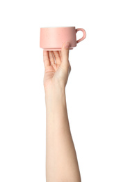 Photo of Woman holding pink ceramic cup on white background, closeup