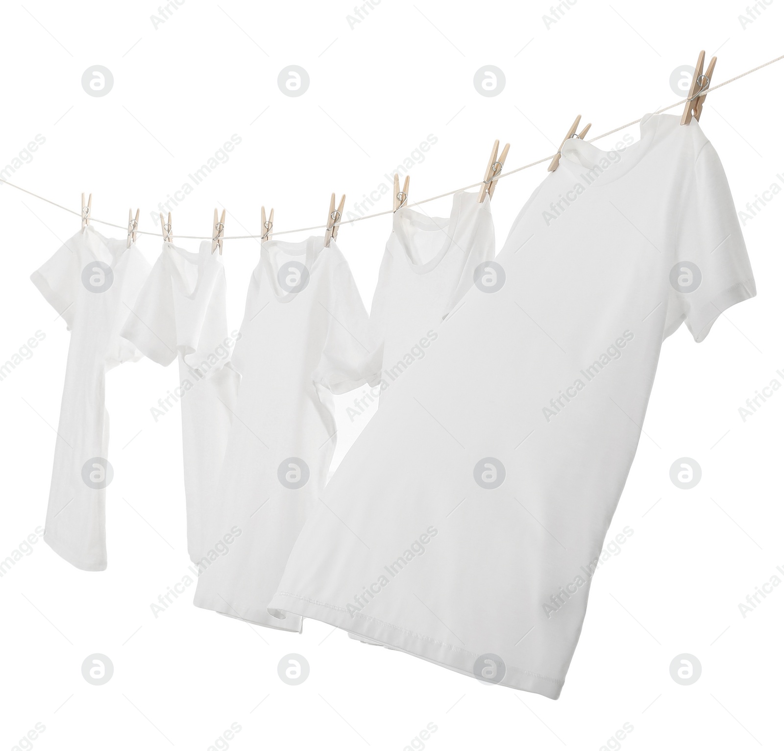 Photo of Many t-shirts drying on washing line isolated on white