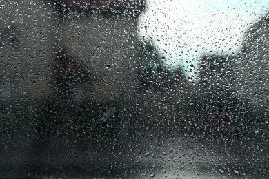 Blurred view of city street from window on rainy day