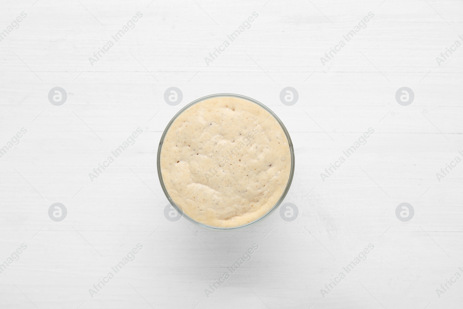 Photo of Leaven on white wooden table, top view