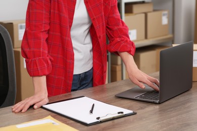 Photo of Seller with laptop working in office, closeup. Online store