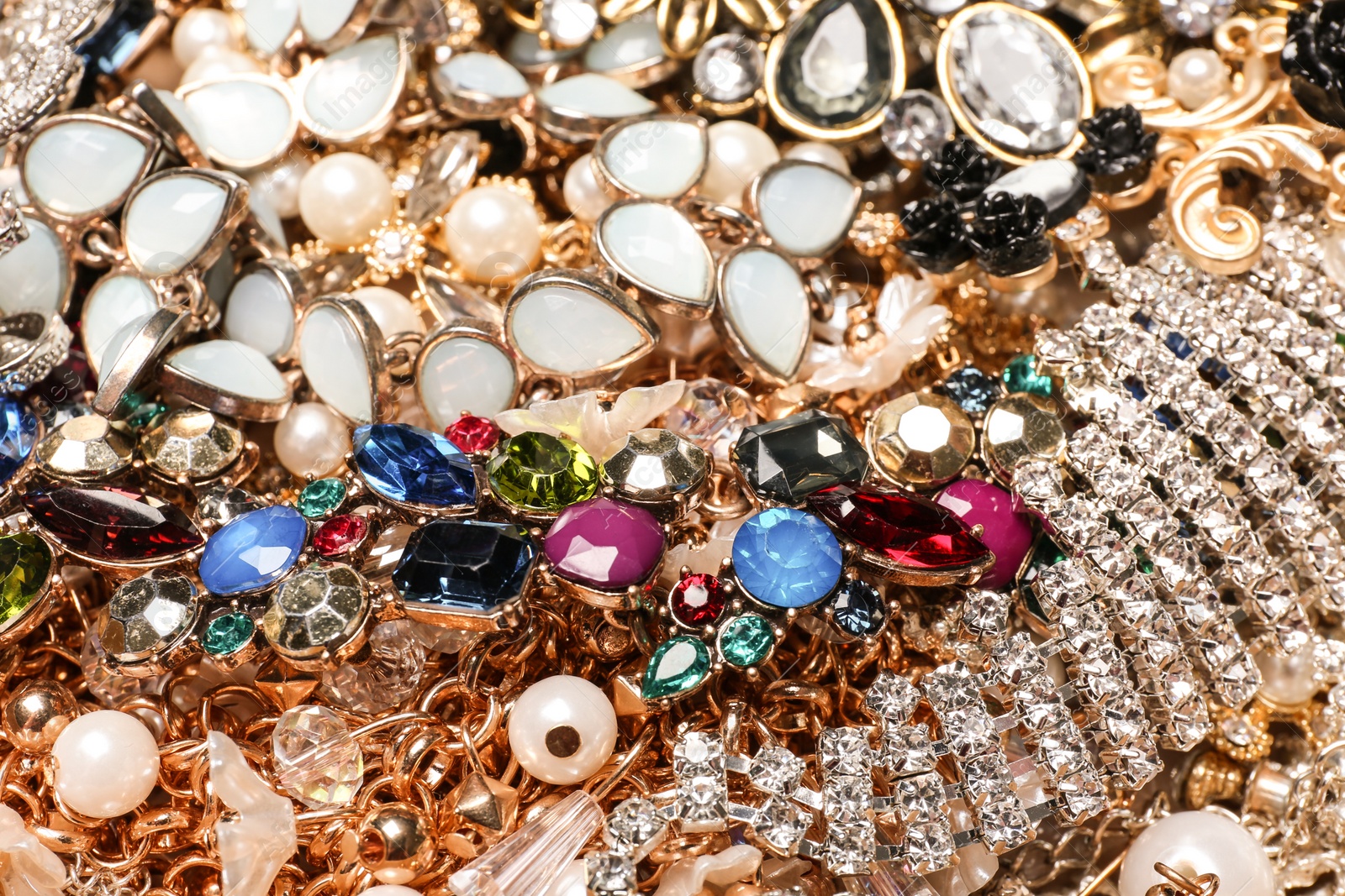 Photo of Different stylish jewelry as background, closeup view