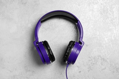 Stylish headphones on grey background, top view