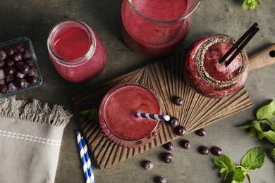 Photo of Flat lay composition with delicious acai juice on dark table